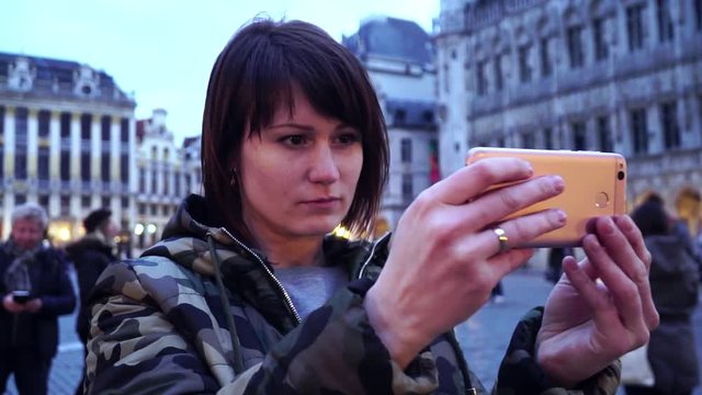 Lady tourist takes pictures on , Belgium.slow motion. dolly zoom effect