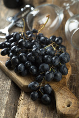 Dark grape on wooden desk