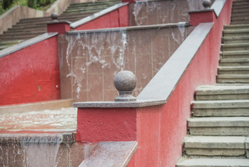 red staircase with a fountain in the middle