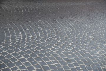 The old road from pavers is laid out in a semicircle