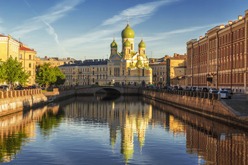 Fototapeta na wymiar Fontanka river embankment in the early morning with St. Isidore Church, St. Petersburg, Russia
