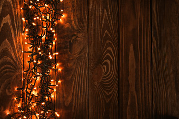 Beautiful bright Christmas garland on wooden background
