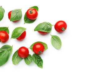 Fresh cherry tomatoes with basil on white background