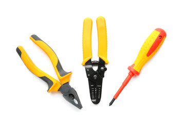 Obraz premium Pliers, wire stripper and screwdriver on white background