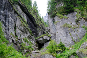 Obraz premium Rumunia, Góry Bucegi - górski widok z wielkim głazem na trasie ze szczytu Omul przez wąwóz do Busteni 