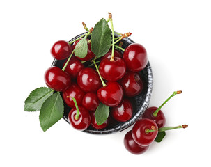 Bowl with ripe cherries on white background