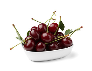 Bowl with ripe cherries on white background