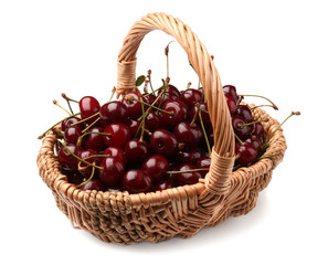 Wicker basket with ripe cherries on white background
