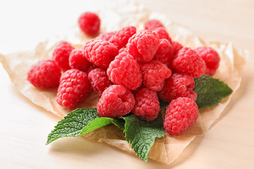 Delicious fresh ripe raspberries on light background