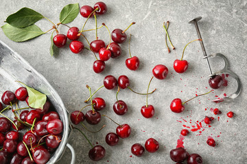 Ripe cherries on grey background