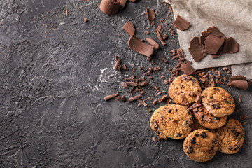 Sweet tasty cookies with chocolate chips on grey textured background