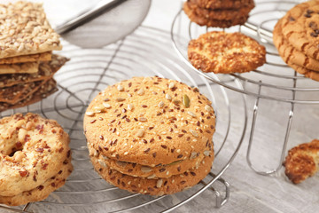 Cooling rack with tasty cookies on table