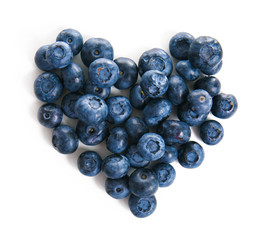 Heart made of ripe blueberries on white background