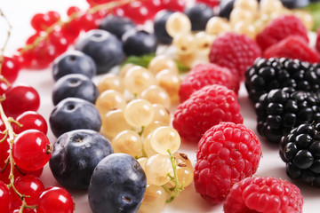 Different ripe berries on table, closeup