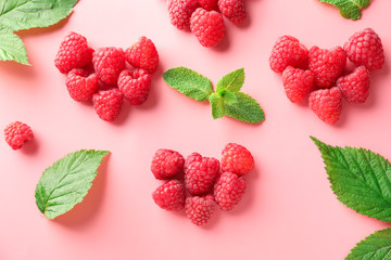 Composition with ripe aromatic raspberries on color background