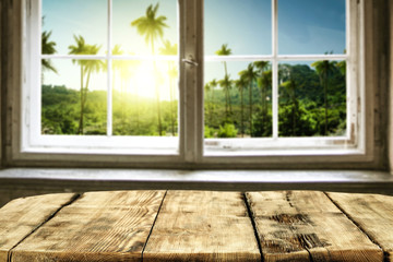 Table background of free space and window background with palms. Summer time. 