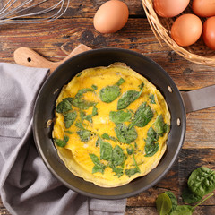 spinach omelet on wood background