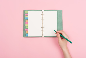 girl's hand writing in notepad