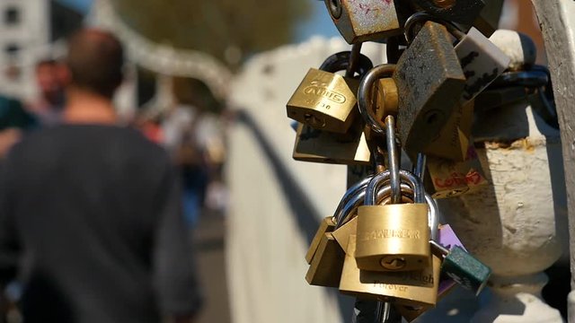 People walking past Love Padlocks on Liffey Bridge, Dublin, Ireland - Slow Motion