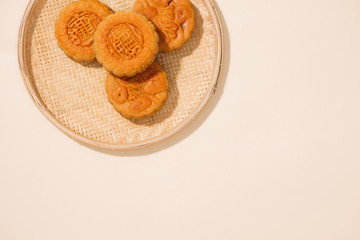 Vietnamese sweet food for mid autumn festival when full moon, moon cake from top view on black wooden background, delicious homemade mooncake of Vietnam cuisine culture