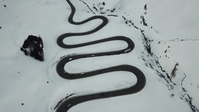 Vehicles traveling up and down the Julier Pass during winter in Switzerland - Aerial View