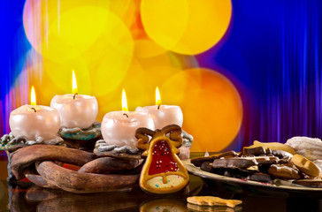 Advent Wreath with Burniíng Candles in  front of Christmas Tree