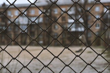 poor neighborhood area behind grid fence