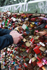 Person locking a padlock on Hohenzollern Bridge, Cologne