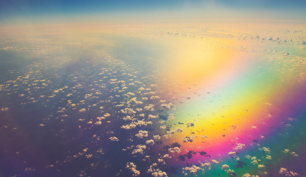aerial panoramic cloudscape over sea in colorful reflection light