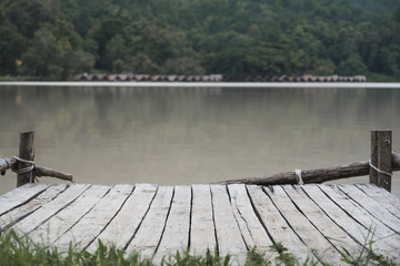 An old wooden pier by the river background