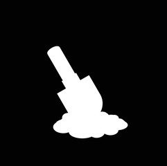 White silhouette of shovel icon in the soil isolated on black