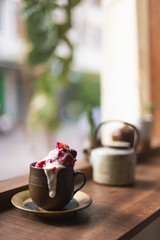 Strawberry sherbet with yogurt in the cup on the wooden table.