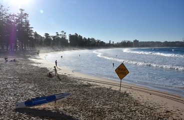 Sydney, Australia - Jul 5, 2018. A sign reads Beach closed. No swimming flag on the beach after storm.