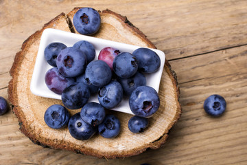 Fresh organic berries on a wooden background.