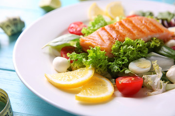 Tasty grilled fish and fresh salad on plate, closeup. Diet concept