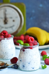 Vanilla yoghurt with raspberries and banana for breakfast. Dietary meals.