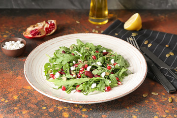Plate with delicious healthy fresh salad on table