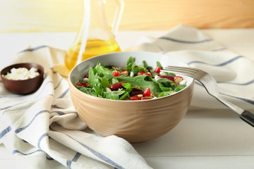 Bowl with delicious healthy fresh salad on table