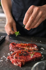 Man preparing meat in kitchen