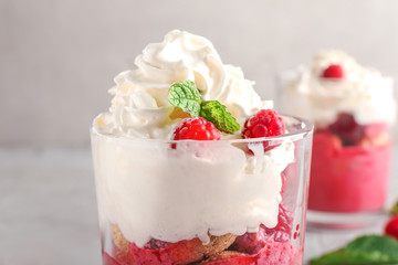 Glass with tasty raspberry dessert, closeup