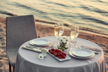 Fototapeta na wymiar Beautiful table setting for romantic date near river