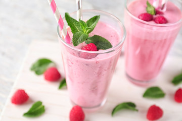Glasses with tasty raspberry smoothie on table