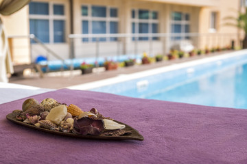 a separate massage area next to a mineral water pool. Body and soul care, rest and spa treatments. bed for massages in the tent and beautiful flowers for an unforgettable holiday.