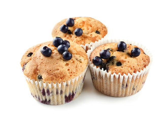 Tasty muffins with blueberries on white background