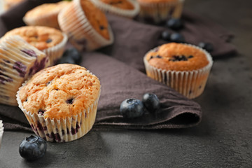 Tasty blueberry muffins on table