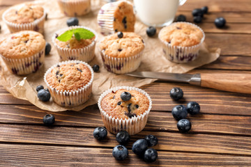 Tasty blueberry muffins on wooden table