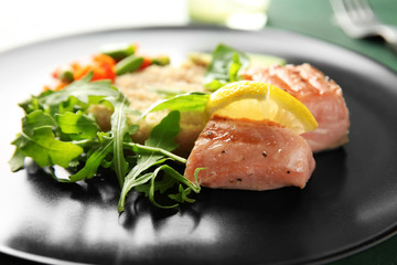 Fresh salad and fish on plate, closeup