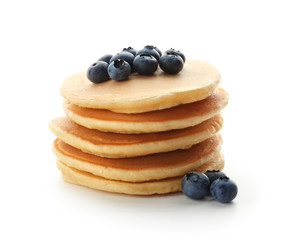 Delicious pancakes with berries on white background