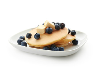 Plate with delicious pancakes and berries on white background