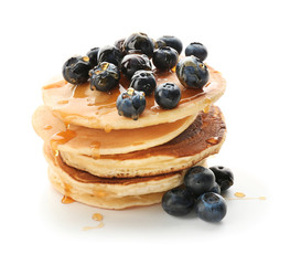 Delicious pancakes with berries and honey on white background